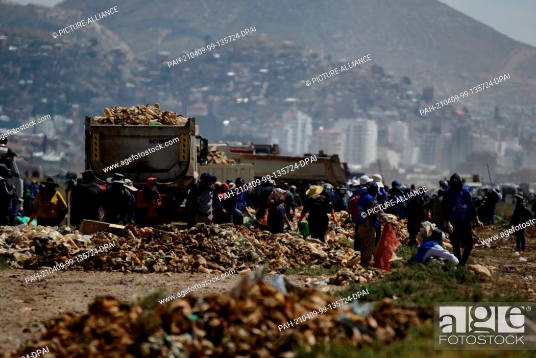 Stock Photo: 07 April 2021, Bolivia, Oruro: Large numbers of people take part in a large-scale cleaning operation at Lake Uru Uru. According to the Oruro government's.
