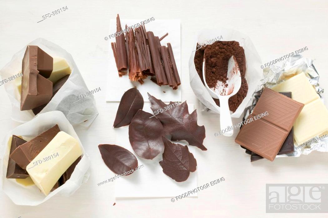Stock Photo: Dark, milk & white chocolate, cocoa, chocolate rolls & leaves.