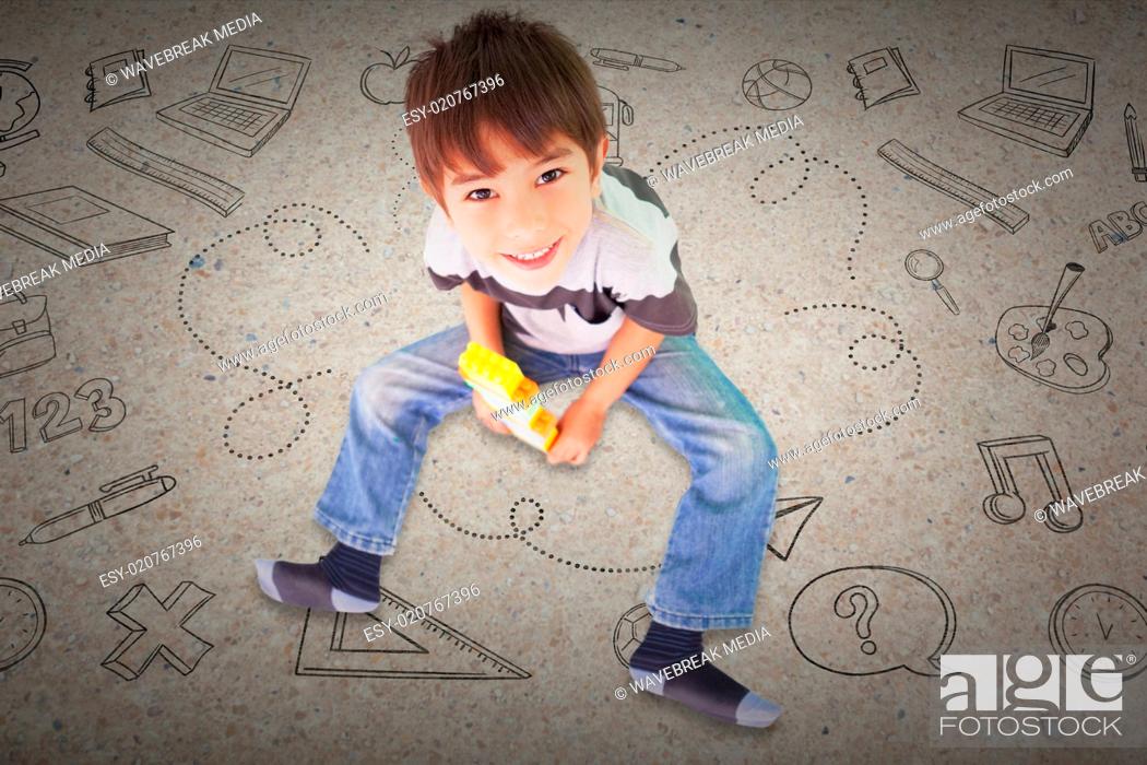 Stock Photo: Composite image of cute boy sitting with building blocks.