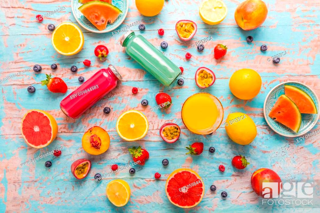 Stock Photo: Variation of smoothies and refreshing drinks with fresh fruits for hot summer on blue background.