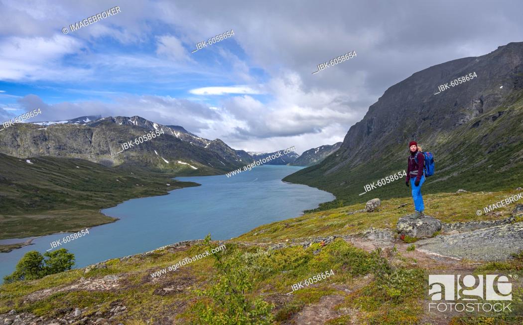 Stock Photo: Lake Gjende, hiker on the Besseggen hike, Jotunheimen National Park, Vågå, Innlandet, Norway, Europe.