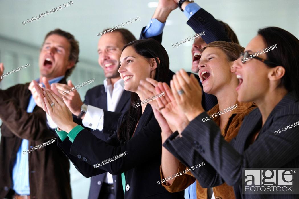 Stock Photo: Business team applauding, smiling.