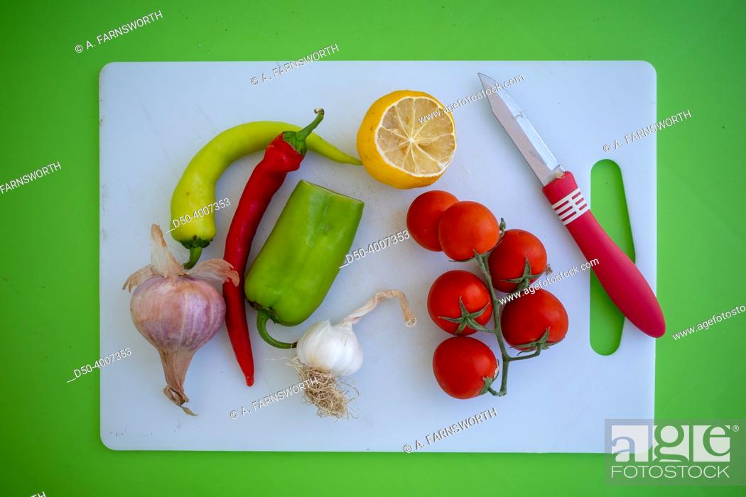 Stock Photo: A plate of fresh vegetables on a green background.