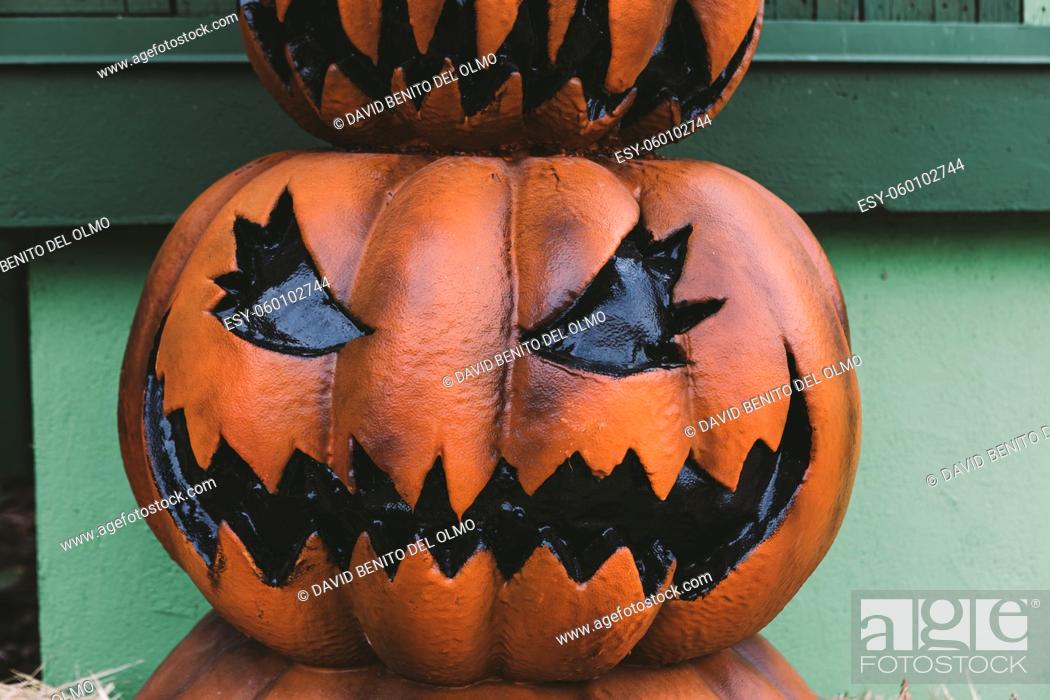 Stock Photo: A Halloween decorative dark colored Jack-o-Lantern pumpkin on the street. Halloween and carnival celebration concept.