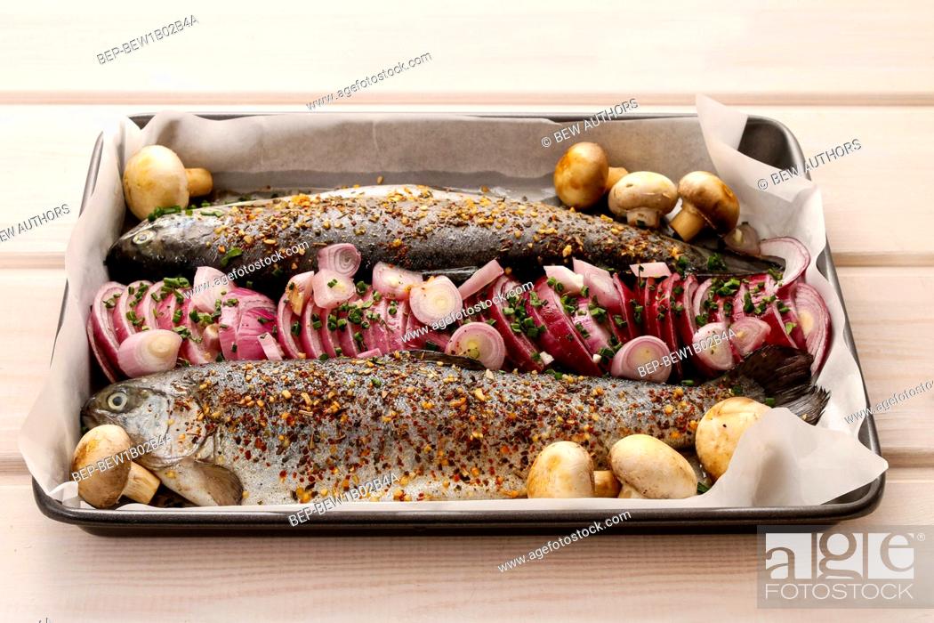 Stock Photo: Rainbow trout with onions before baking. Healthy food.