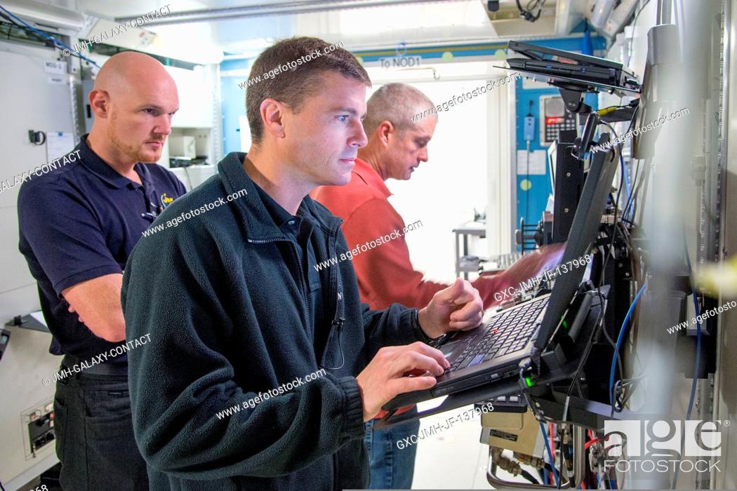 Stock Photo: NASA astronaut Steve Swanson (background), Expedition 39 flight engineer and Expedition 40 commander; along with NASA astronaut Reid Wiseman (foreground) and.
