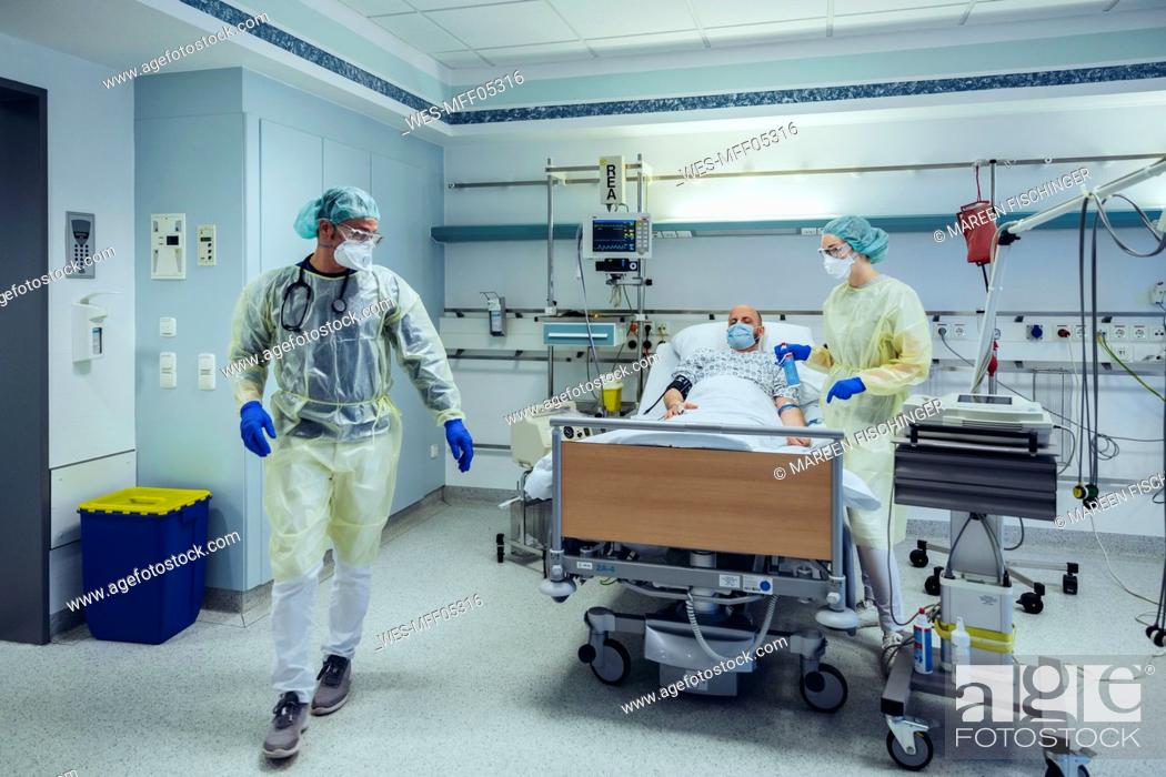 Stock Photo: Doctors caring for patient in emergency care unit of a hospital.