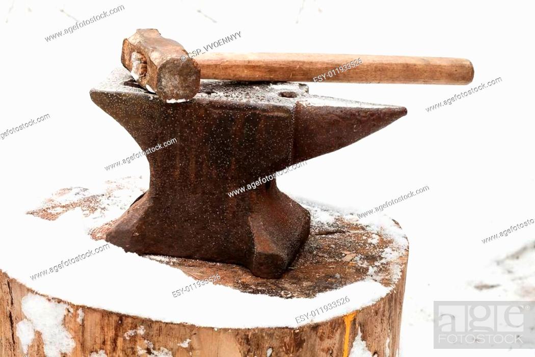 Stock Photo: anvil with hammer in old abandoned village smithy.