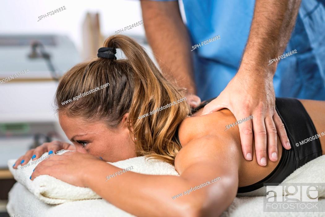 Stock Photo: Physical therapy. Therapist applying strong pressure to shoulder muscles.