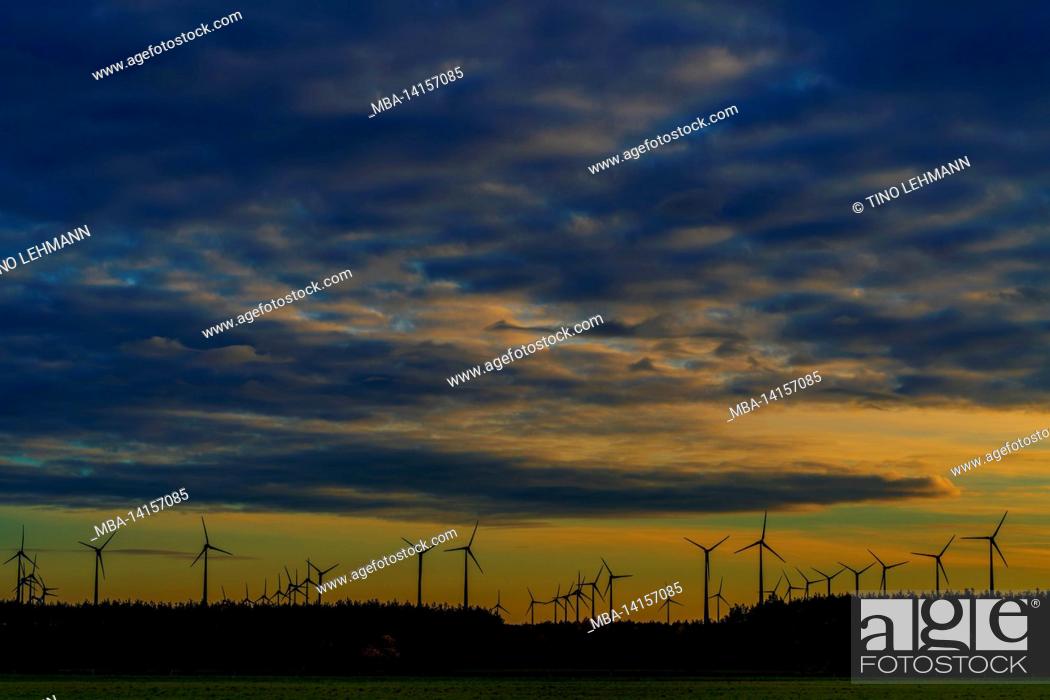 Stock Photo: many wind turbines just before sunset, beautiful cloudy sky.