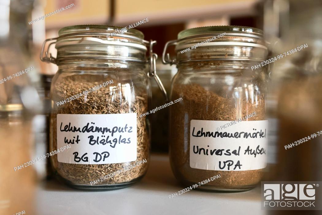 Stock Photo: 24 March 2023, Thuringia, Gierstädt: Jars with different clay building materials stand on a table in the clay plant. Environment Minister Stengele is here today.