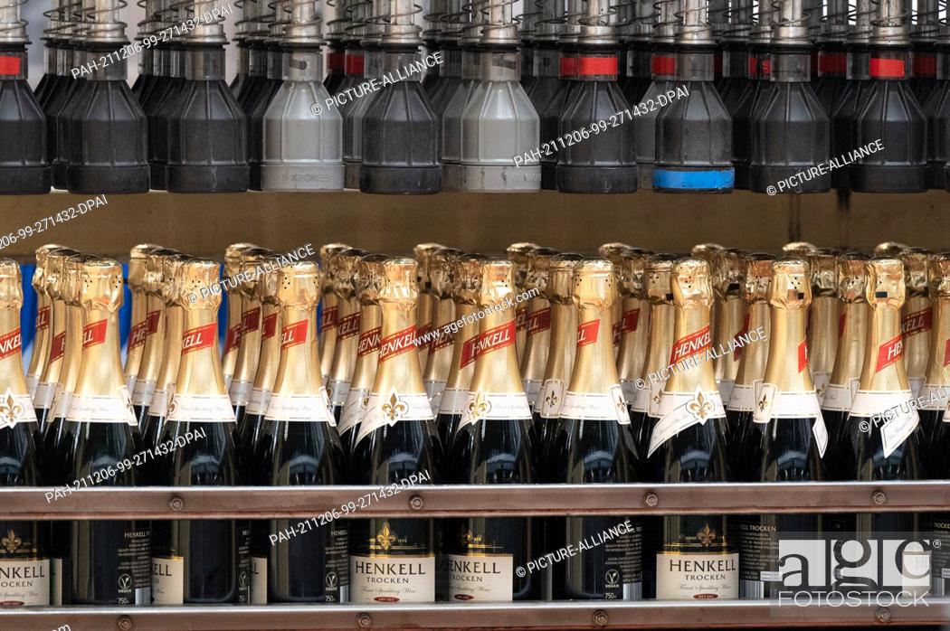 Stock Photo: 09 November 2021, Hessen, Wiesbaden: Sparkling wine bottles of Henkell Trocken are transported during production at the Henkell & Co.