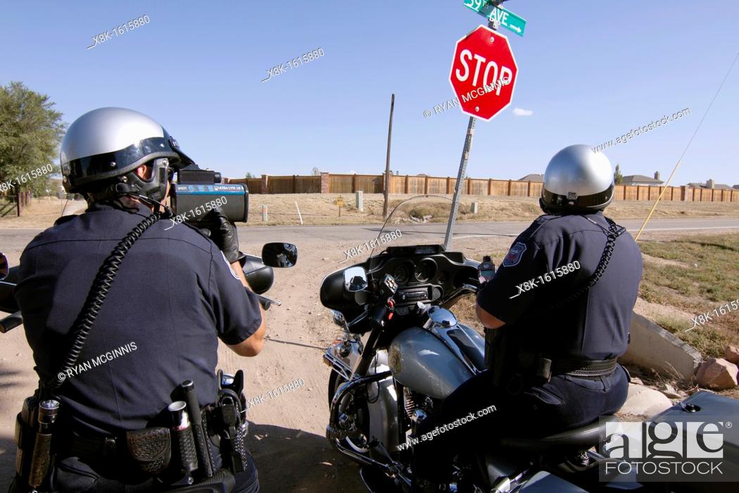 Stock Photo: Police officers use radar to check the speed of motorists in Greely, Colorado, USA, October 3, 2011.