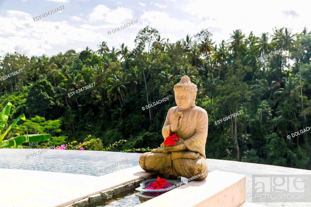 Stock Photo: travel, vacation, tourism, religion and luxury concept - beautiful view from infinity edge pool with buddha statue to tropical woods in asia.