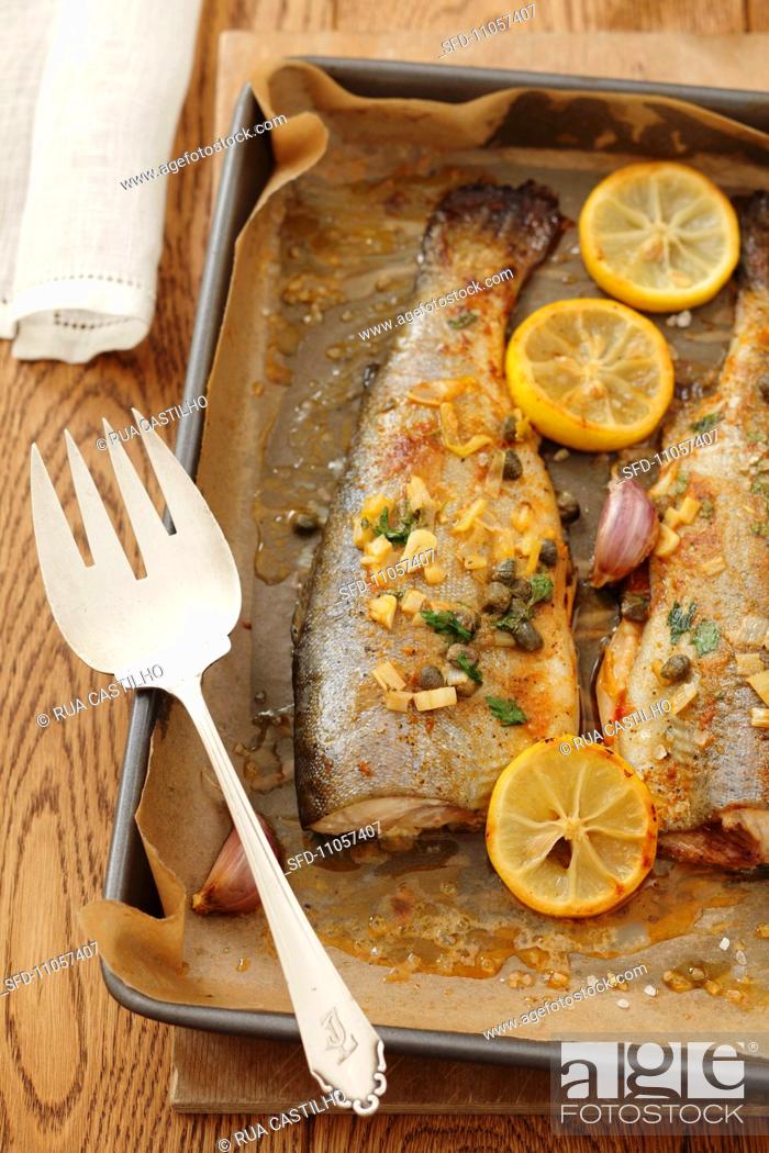 Stock Photo: Trout with capers, garlic and lemons.
