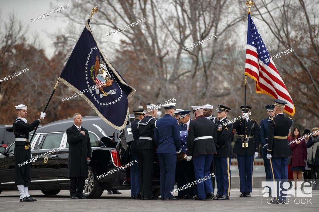 Stock Photo: A joint service honor guard carries the casket of former US President George H.W. Bush out of the US Capitol in Washington, DC, USA, 05 December 2018.