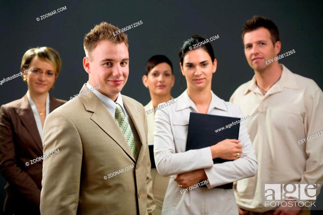 Stock Photo: Businessman standing in front of his smiling team.