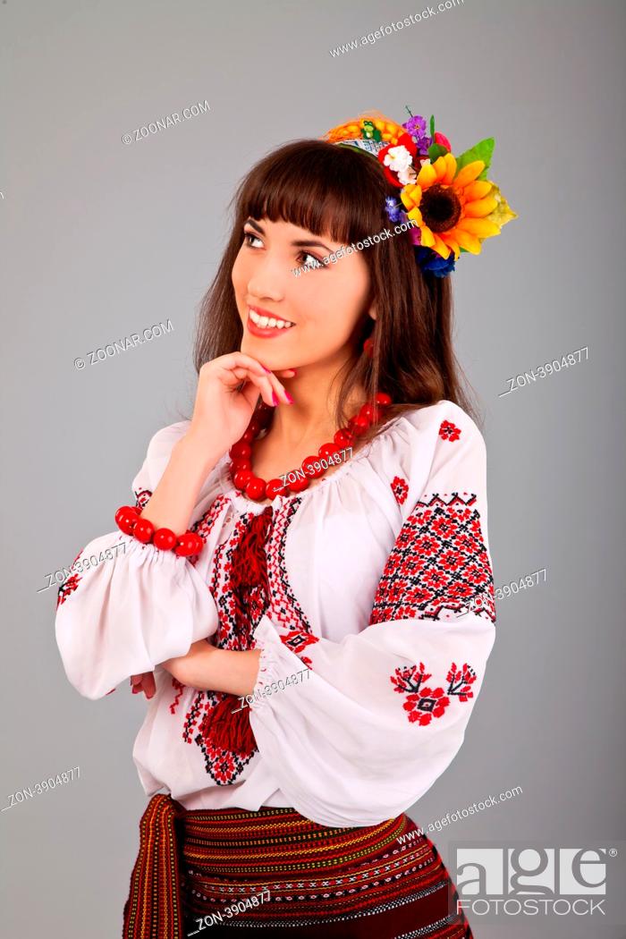 Stock Photo: Attractive woman wears Ukrainian national dress isolated on a white background.