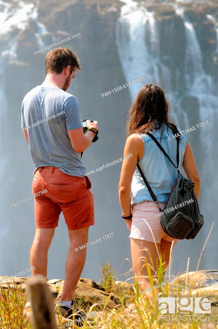 Stock Photo: Tourists visiting the Zimbabwean side of the Victoria Falls, pictured on 30.07.2015. The Victoria Falls are the broad waterfalls of the Zambezi at the border.