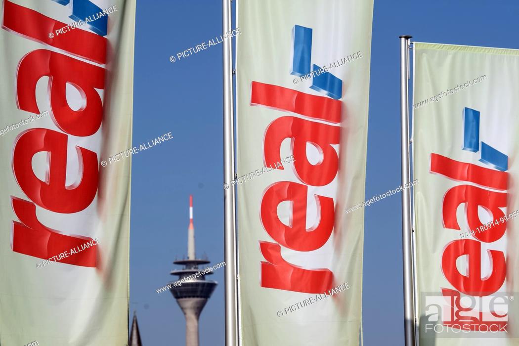 Stock Photo: 14 September 2018, North Rhine-Westphalia, Duesseldorf: Flags with the Real logo waving in front of a Real supermarket. The Metro retail group plans to sell the.