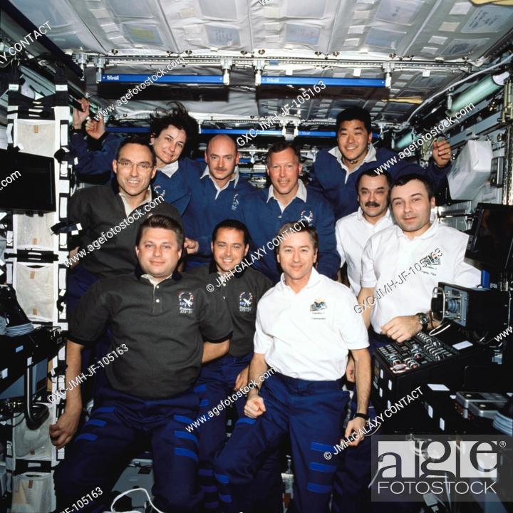 Stock Photo: The Expedition Four (green shirts), STS-108 (blue shirts), and Expedition Three (white shirts) crews assemble in the Destiny laboratory on the International.