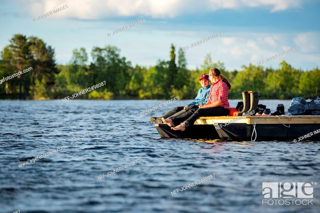 Stock Photo: Woman relaxing on motor raft.