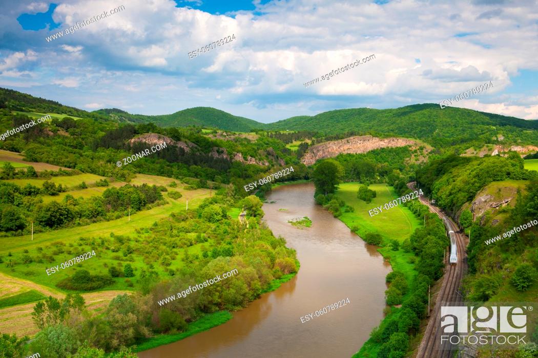 Stock Photo: View from the hill into the valley with the Berounka river. Berounka river, limestone rocks, meadows, fields and railroad track.