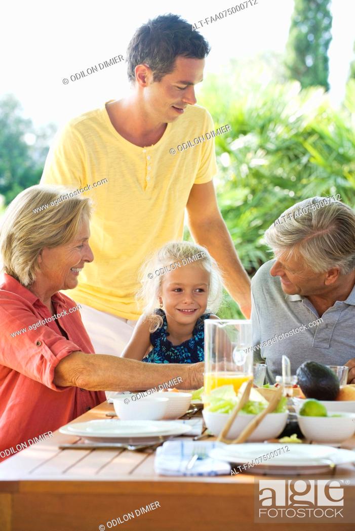 Stock Photo: Multi-generation family having meal outdoors.