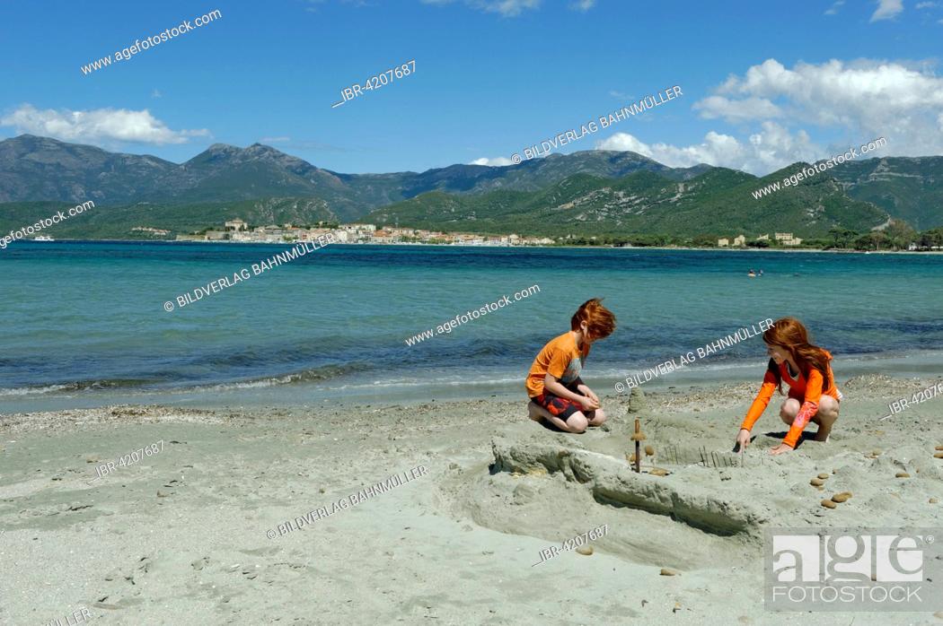 Stock Photo: Children playing on the beach and bay of Saint Florent, Haute-Corse, Nebbio, North Coast, Corsica, France.