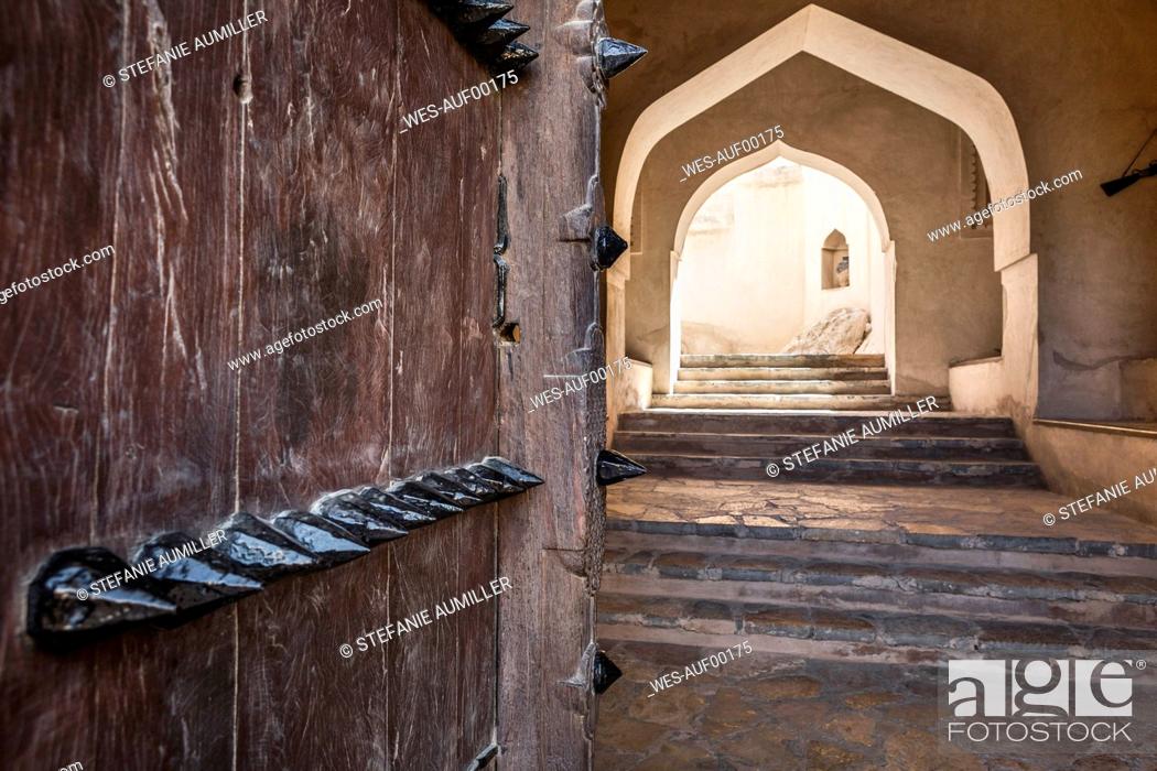 Stock Photo: Oman, Ad Dakhiliyah, Bahla, Spiked door and arched stairway inside Bahla Fort.