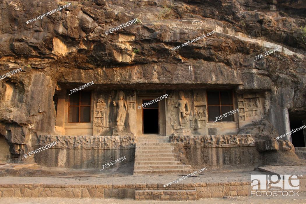 Stock Photo: Outside view of Cave 2, doorway is flanked by huge Bodhisattvas with converging dwarfs above, Buddhist Caves, Ellora, Aurangabad, Maharashtra.