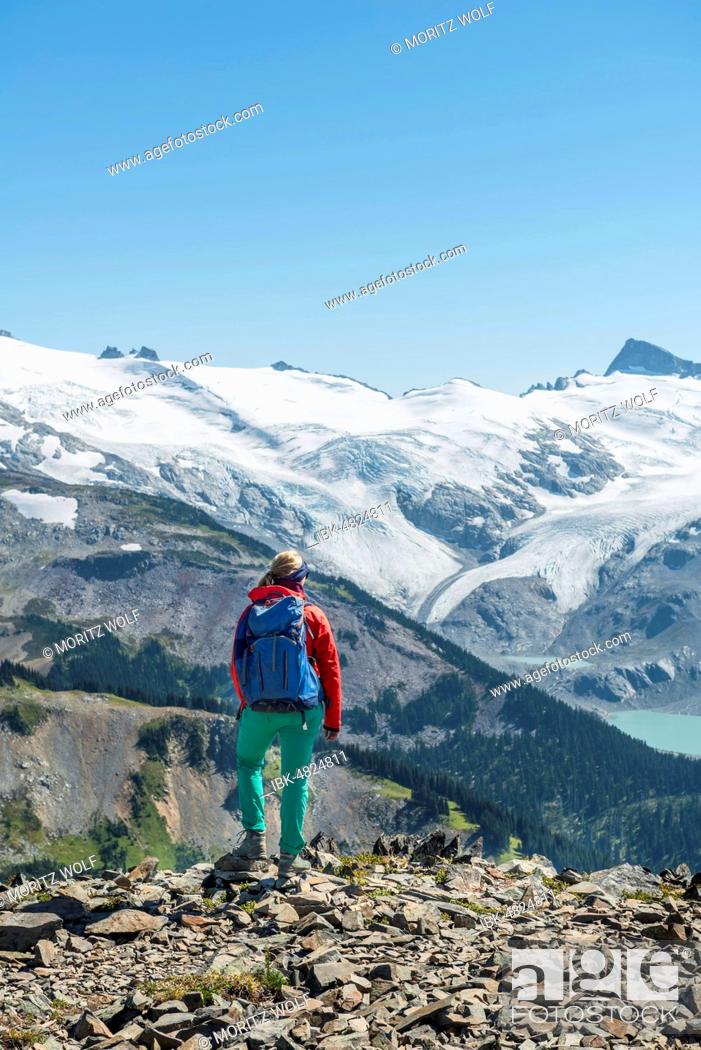Stock Photo: View from Panorama Ridge, Hiker in front of a mountain range with glacier, Guard Mountain and Deception Peak, Garibaldi Provincial Park, British Columbia.