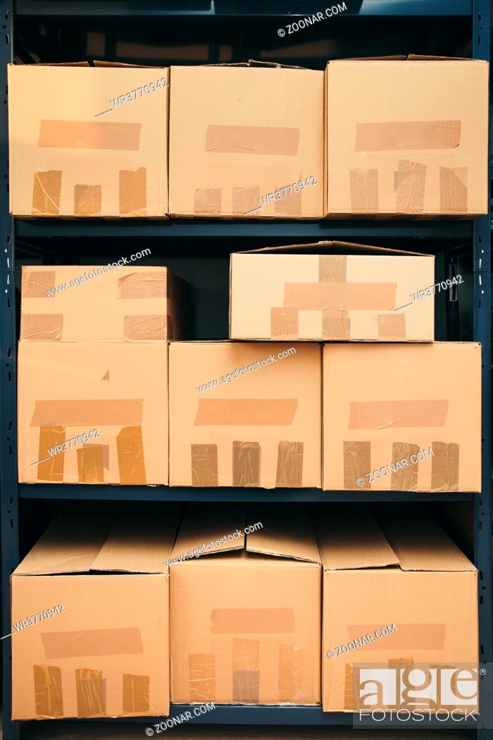 Stock Photo: Cardboard boxes on shelves.