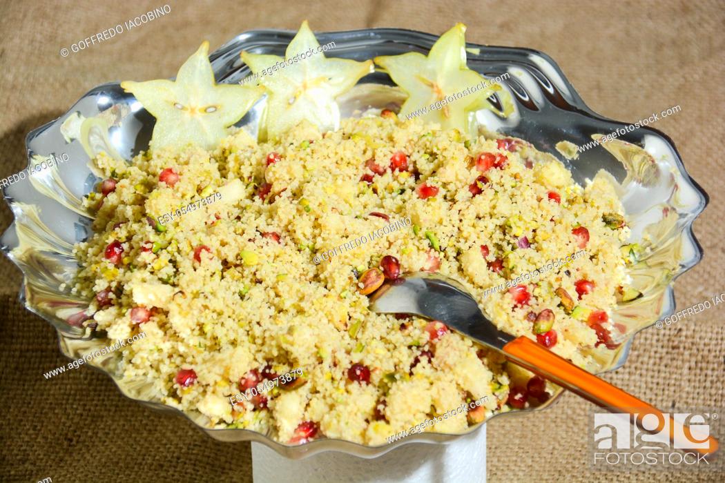 Stock Photo: Italian couscous with pomegranate corn pistachios and thinly sliced vegetables.
