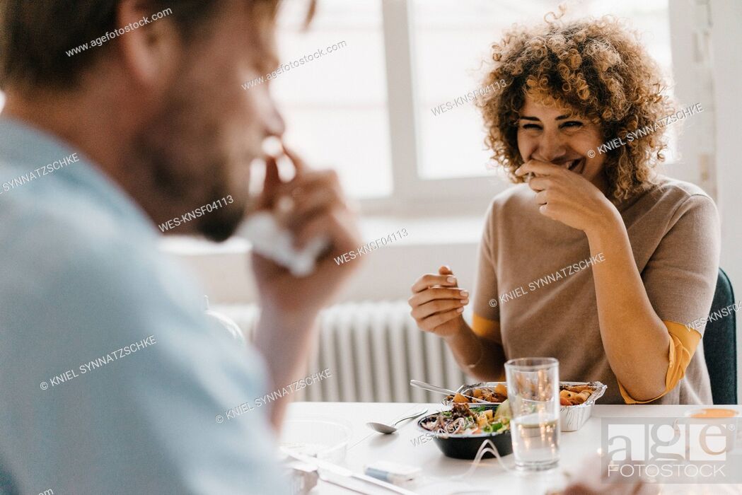 Stock Photo: Colleagues joking at lunch break, eating healthy food.