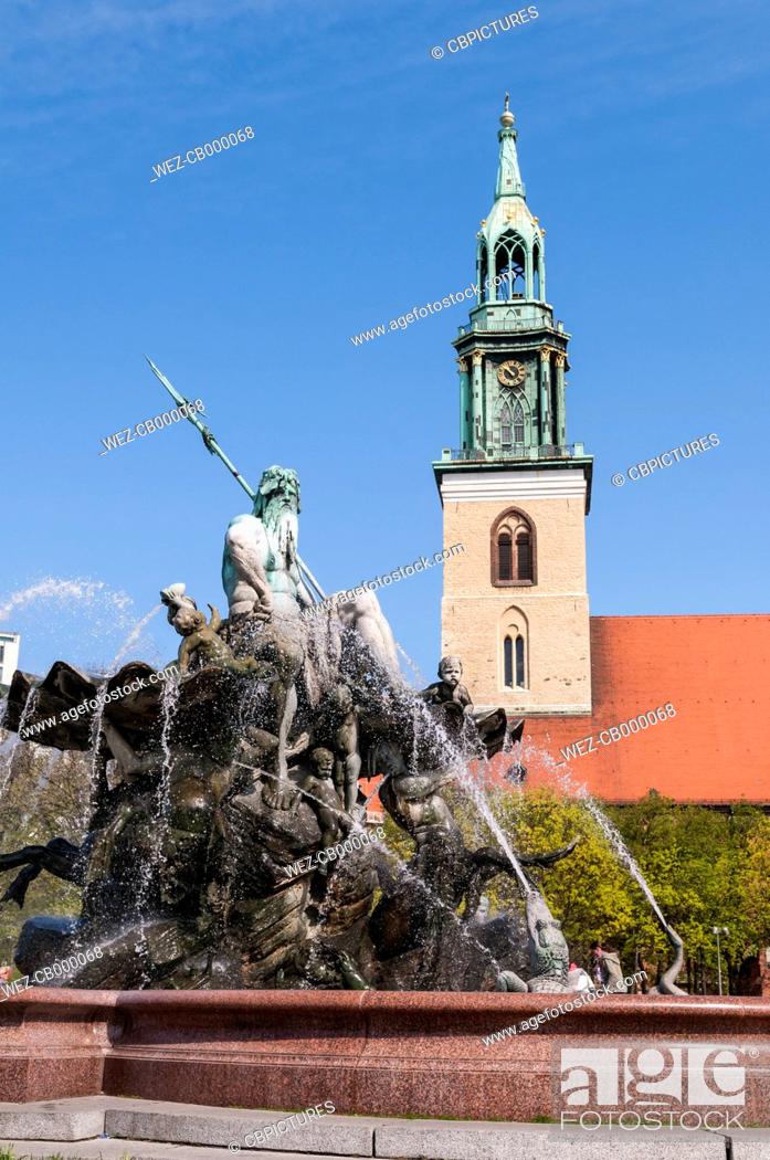 Stock Photo: Germany, Berlin, View of Neptunbrunnen fountain with Saint Marys Church in background.