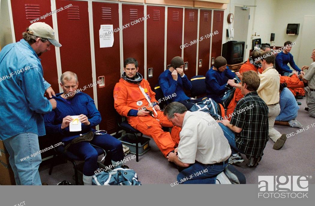Stock Photo: The STS-111 crewmembers and the Expedition Five crewmembers don training versions of the shuttle launch and entry suit prior to a mission training session in.