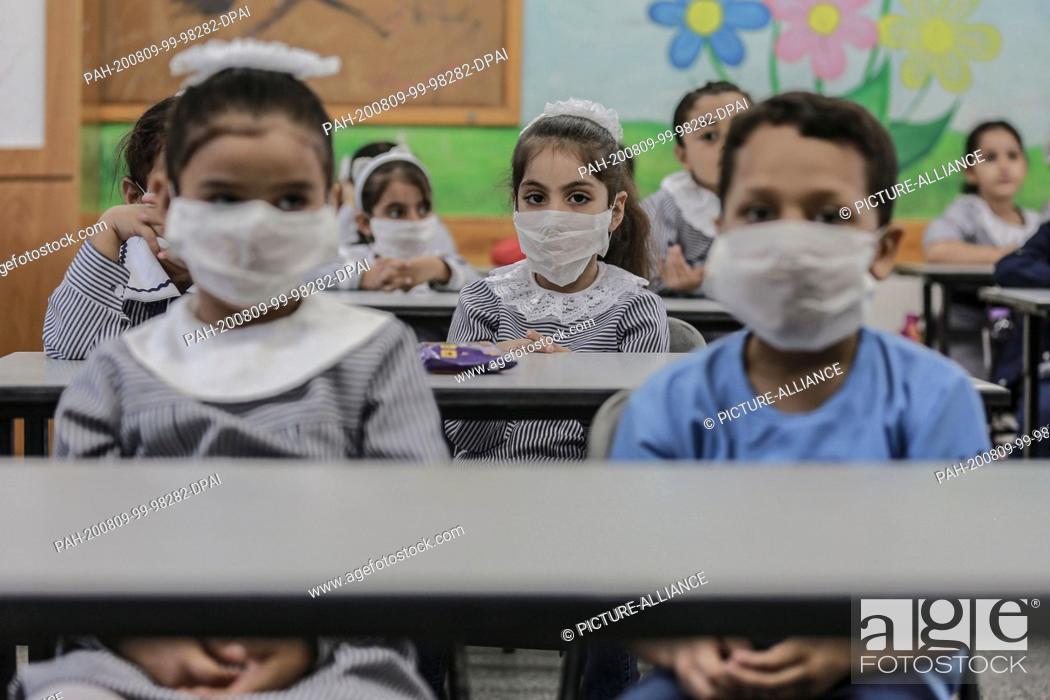 Stock Photo: 09 August 2020, Palestinian Territories, Al-Shati: Palestinian students sit inside a classroom at a school run by the United Nations Relief and Works Agency for.