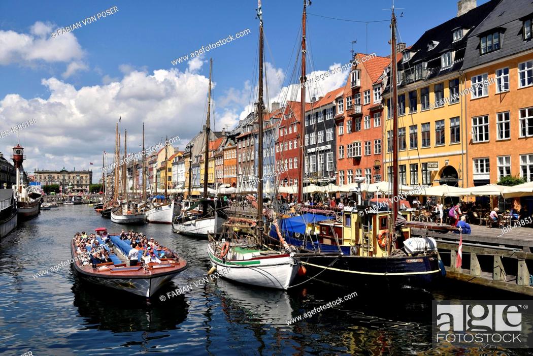 Stock Photo: Excursion boats on canal in front of colorful facades, Nyhavn, Copenhagen, Denmark.