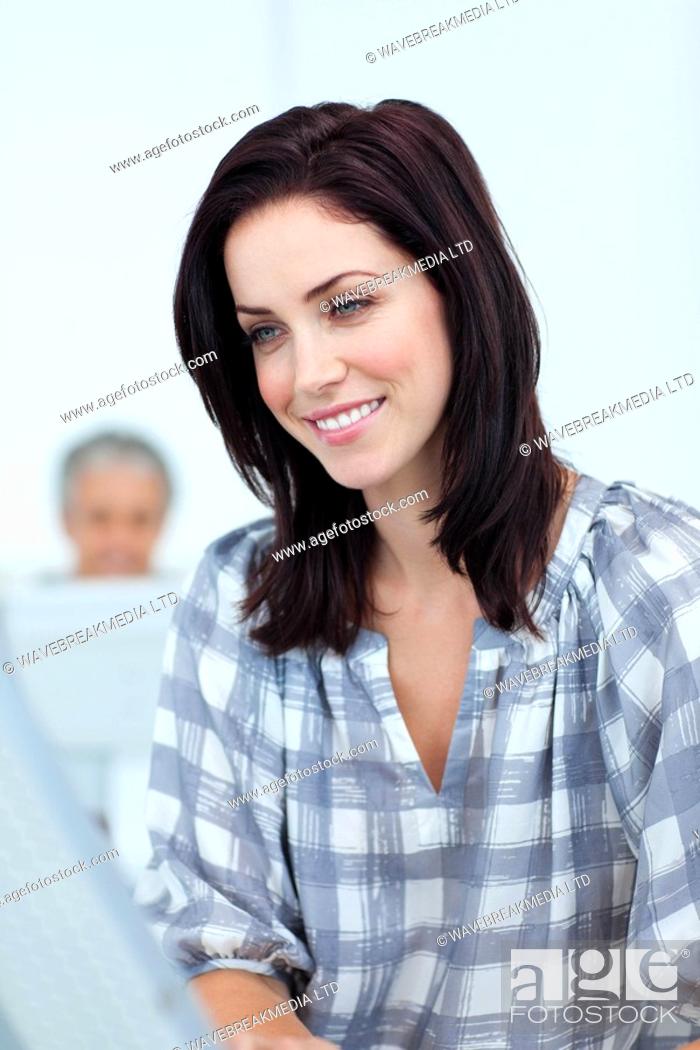 Stock Photo: Portrait of a smiling young businesswoman at work.