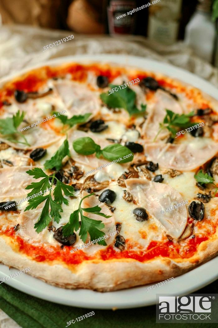 Stock Photo: Pizza with ham, mushrooms and olives.