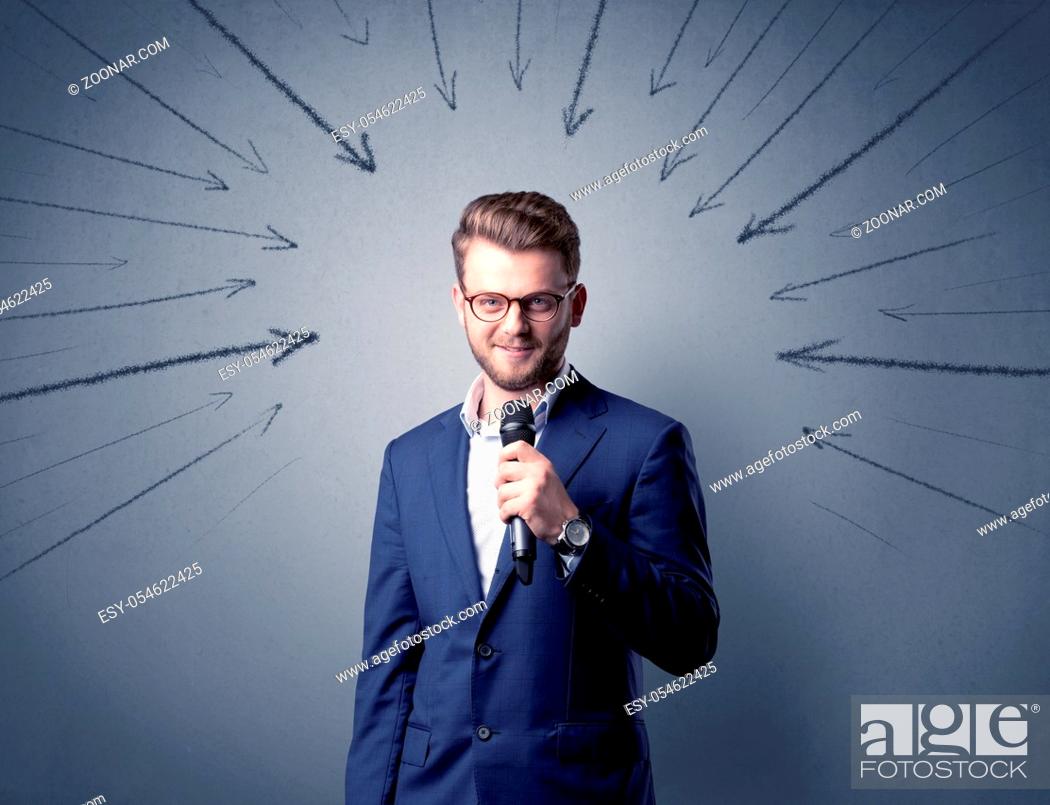 Stock Photo: Businessman speaking into microphone with arrows pointing towards his head.