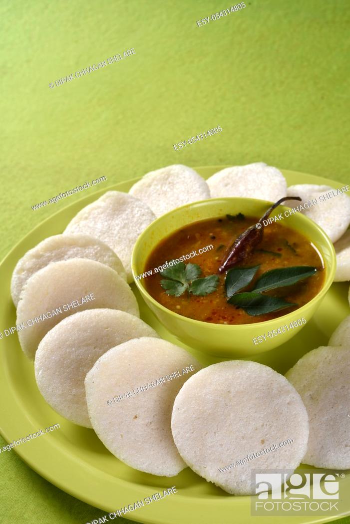 Stock Photo: Idli with Sambar in bowl on green background, Indian Dish : south Indian favourite food rava idli or semolina idly or rava idly.