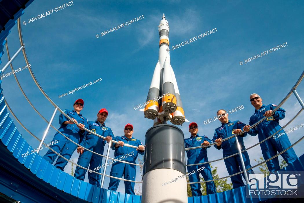 Stock Photo: At the Cosmonaut Hotel crew quarters in Baikonur, Kazakhstan, the Expedition 53-54 prime and backup crewmembers pose for photos around a Soyuz rocket mock up.