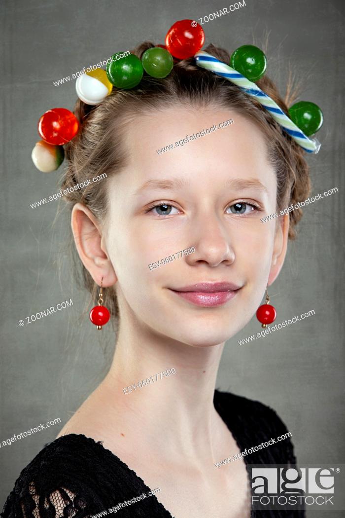 Stock Photo: Portrait of a funny teenage girl with a wreath of sweets on her head.