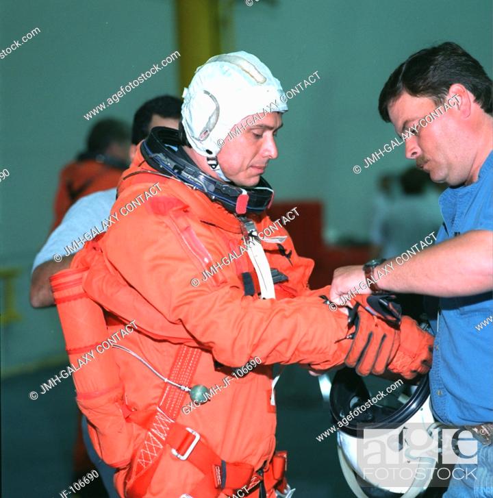Stock Photo: Astronaut Franklin R. Chang-Diaz, STS-91 mission specialist, equipped with parachute and other gear, is preparing for the start of an emergency bailout training.