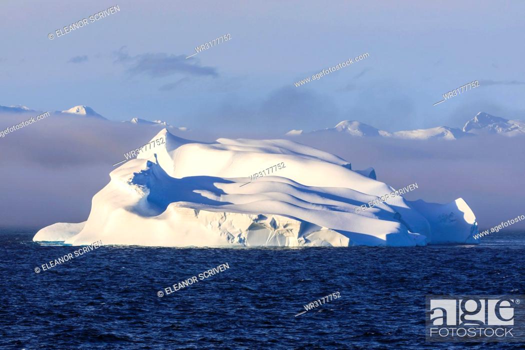 Imagen: Huge iceberg, evening light, clearing mist, Bransfield Strait, near South Shetland Islands and Antarctic Peninsula, Antarctica, Polar Regions.