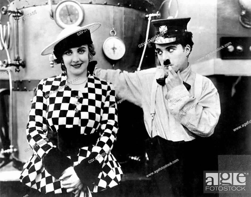 Stock Photo: Edna Purviance and Charlie Chaplin on-set of the Film, The Fireman, 1916.