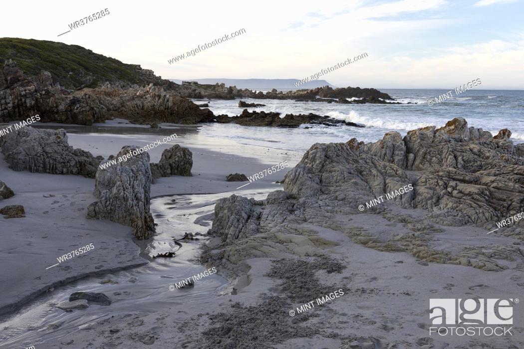 Stock Photo: A deserted beach, jagged rocks and rockpools on the Atlantic coast.