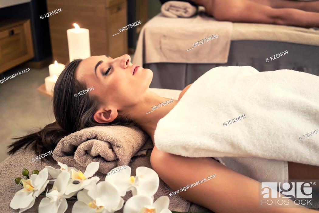 Stock Photo: Young man and woman lying down on massage beds at Asian luxury spa and wellness center.